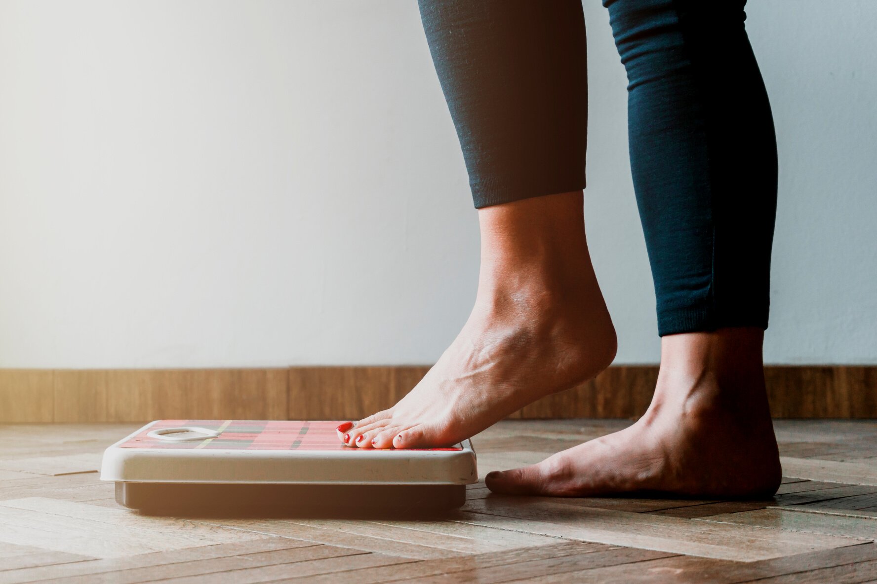 Person Stepping into a Bathroom Scale